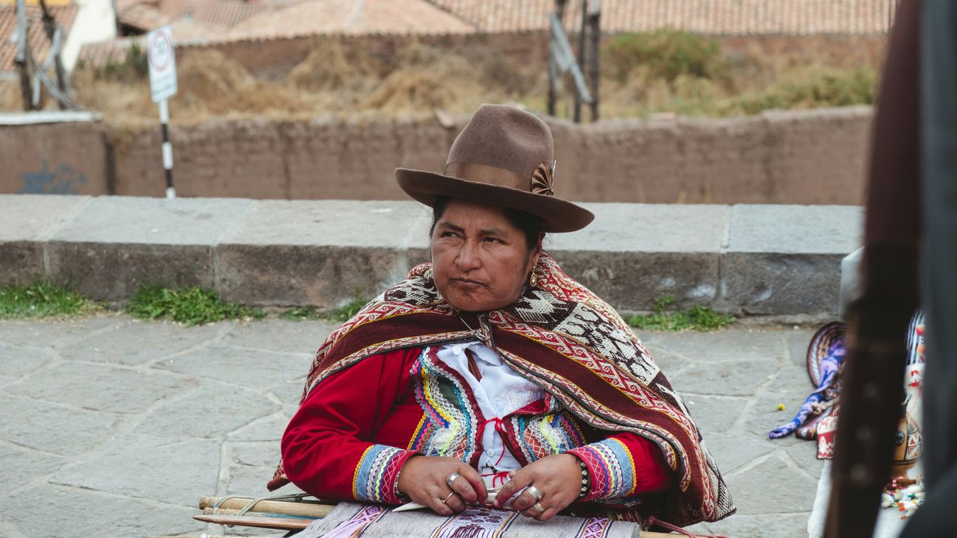 a woman wearing a brown hat sitting at a table
