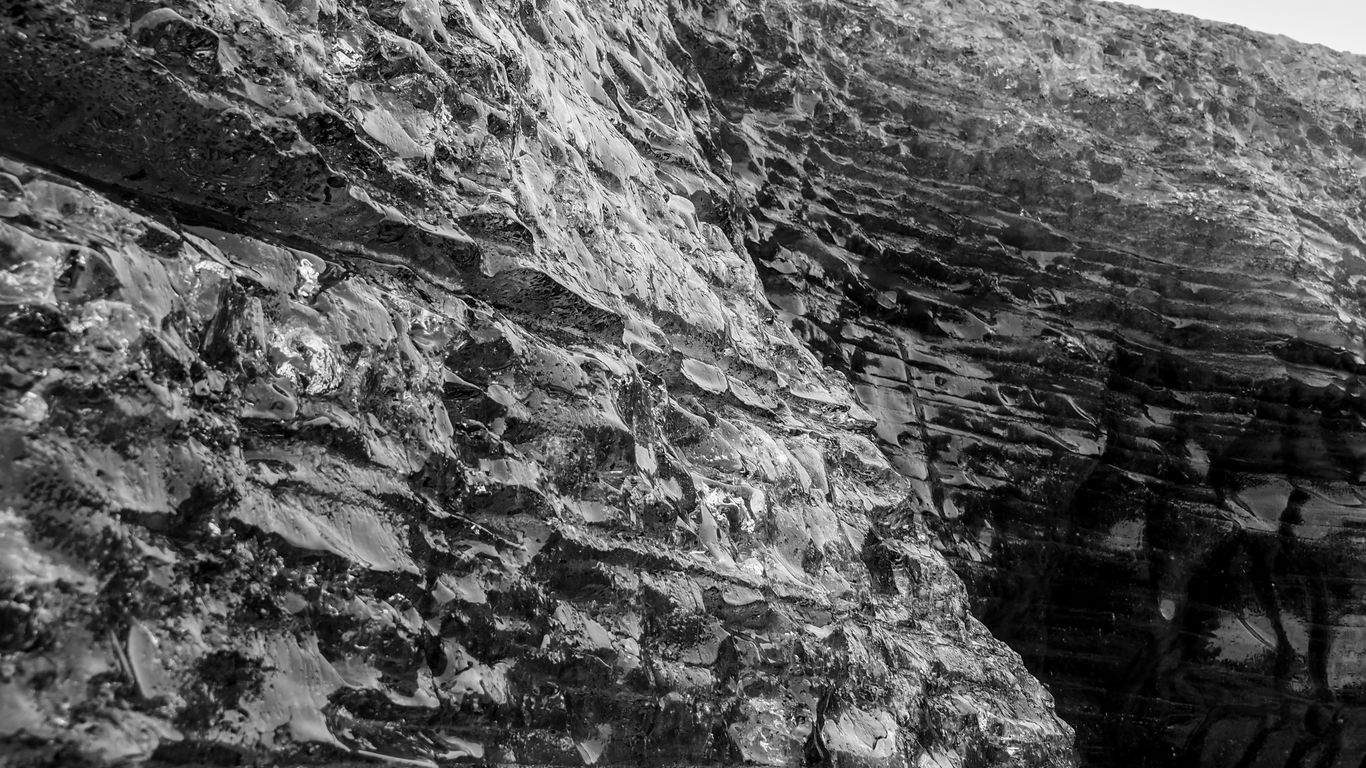a black and white photo of a stone wall