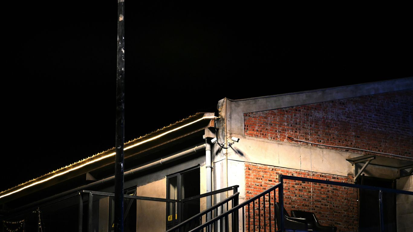 Building exterior at night with brick wall detail