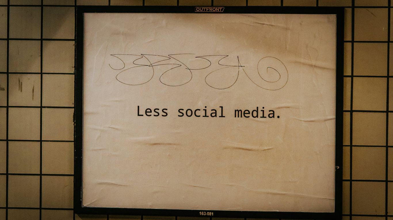 a sign on a wall that says less social media