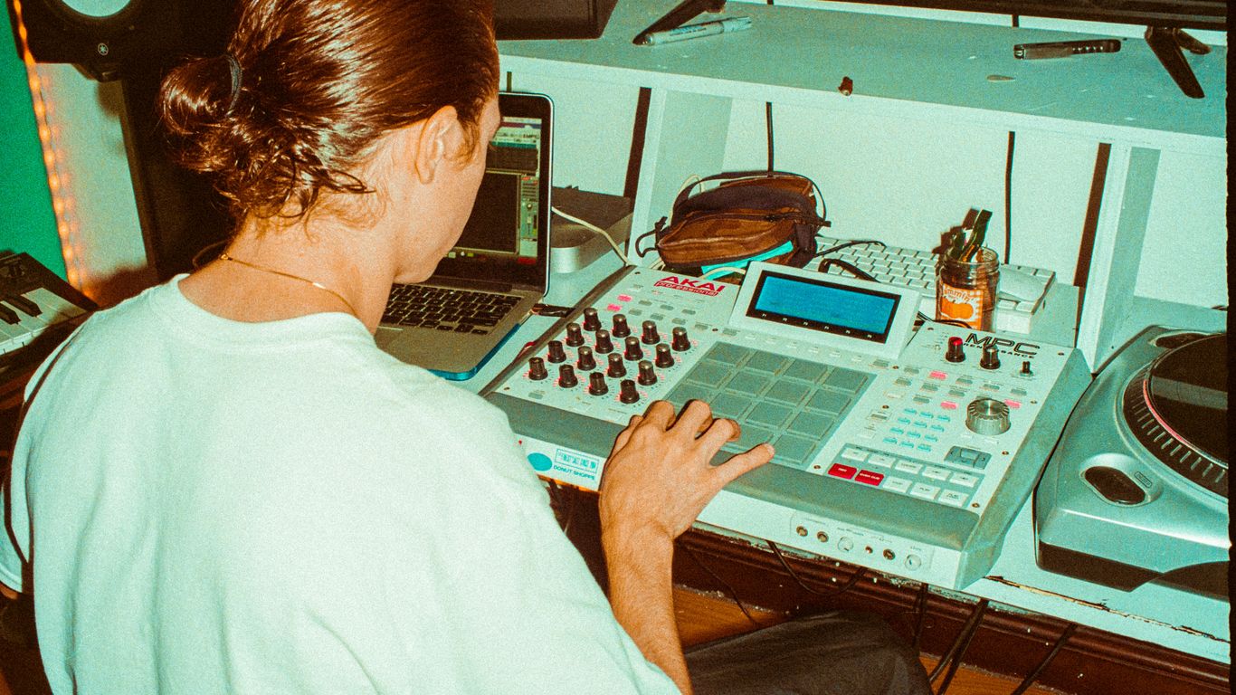 a woman sitting in front of a mixing desk
