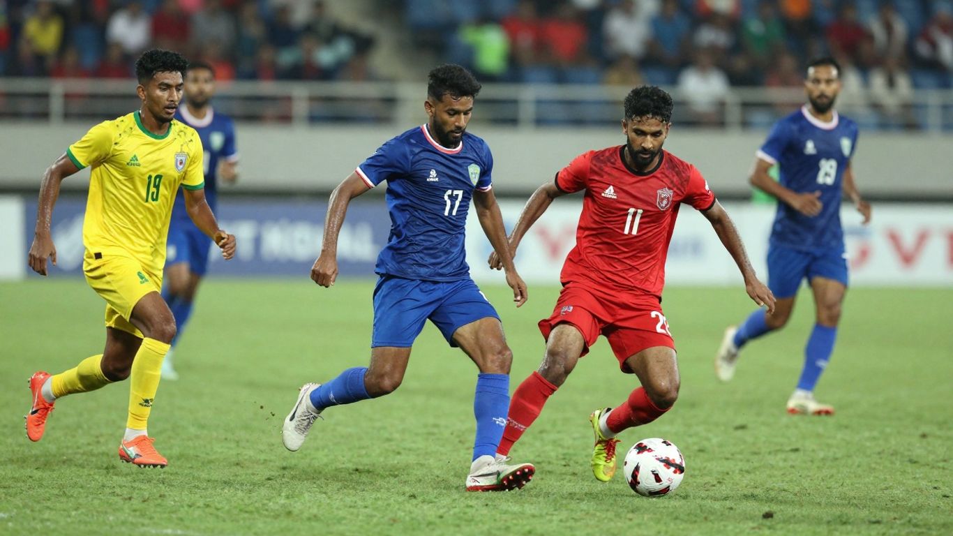 Football players competing intensely on a green pitch.