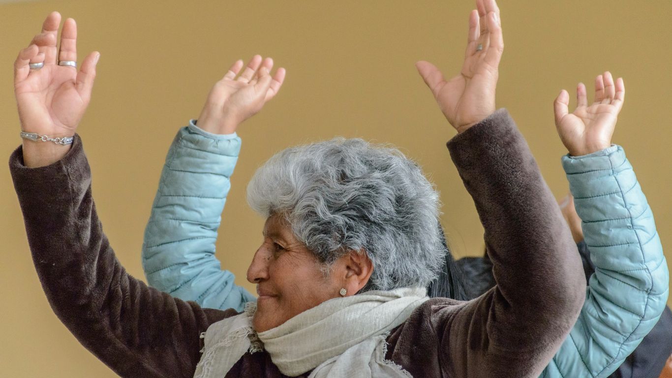 a woman with her hands up in the air