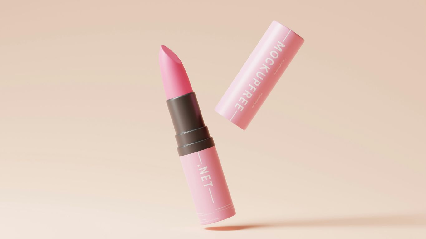 a pink lipstick with a brown cap on a pink background