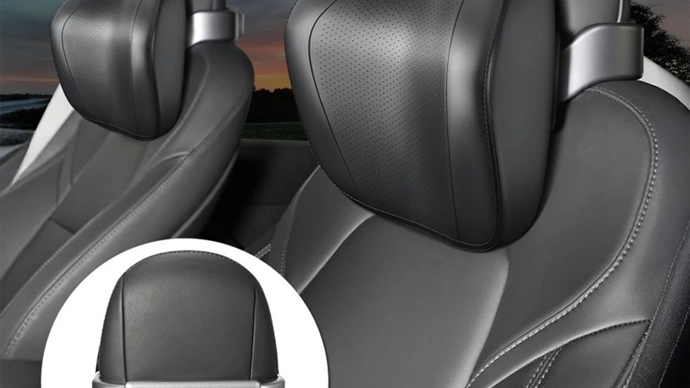 Two sleek car seats with ergonomic neck pillows inside.