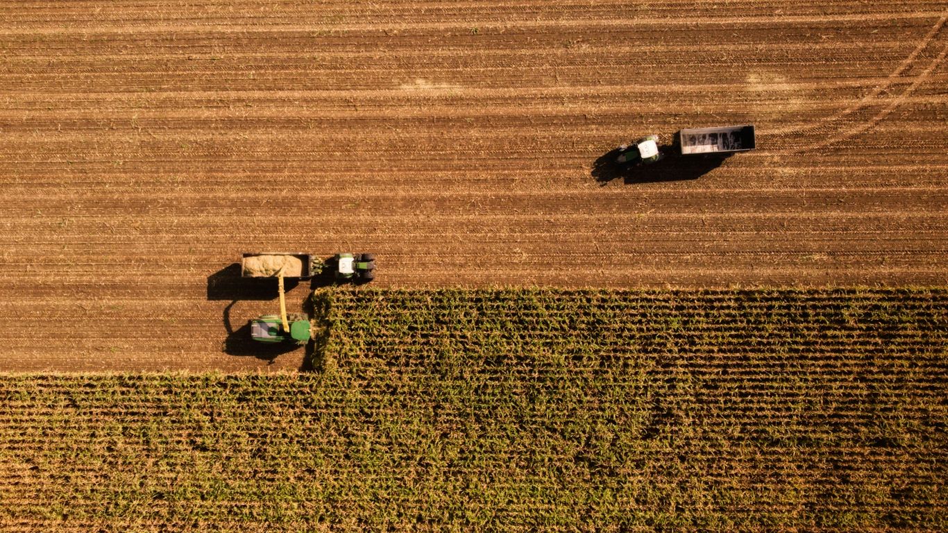 a tractor and a tractor trailer in a field
