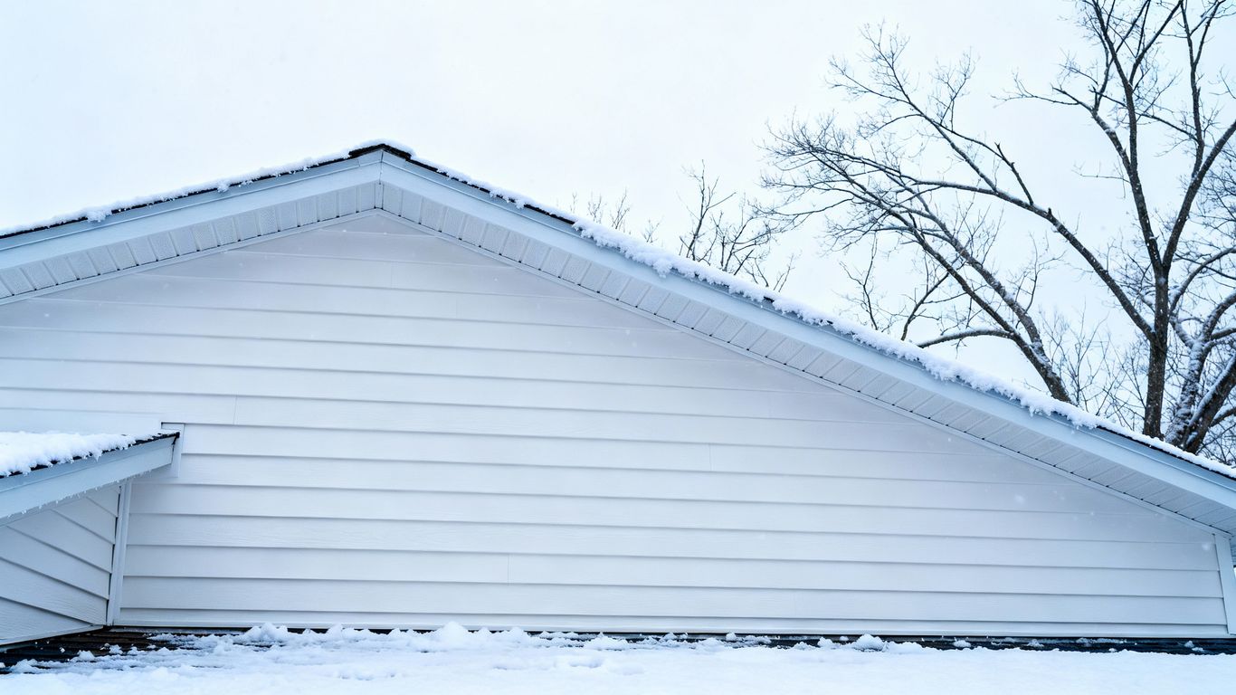 House with new white siding in winter.