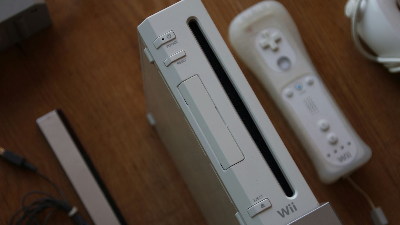 a nintendo wii game system sitting on top of a wooden table