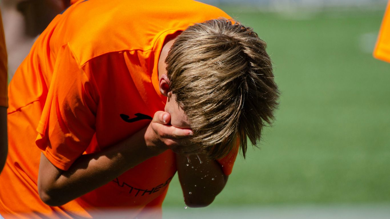a young boy with his head in his hands