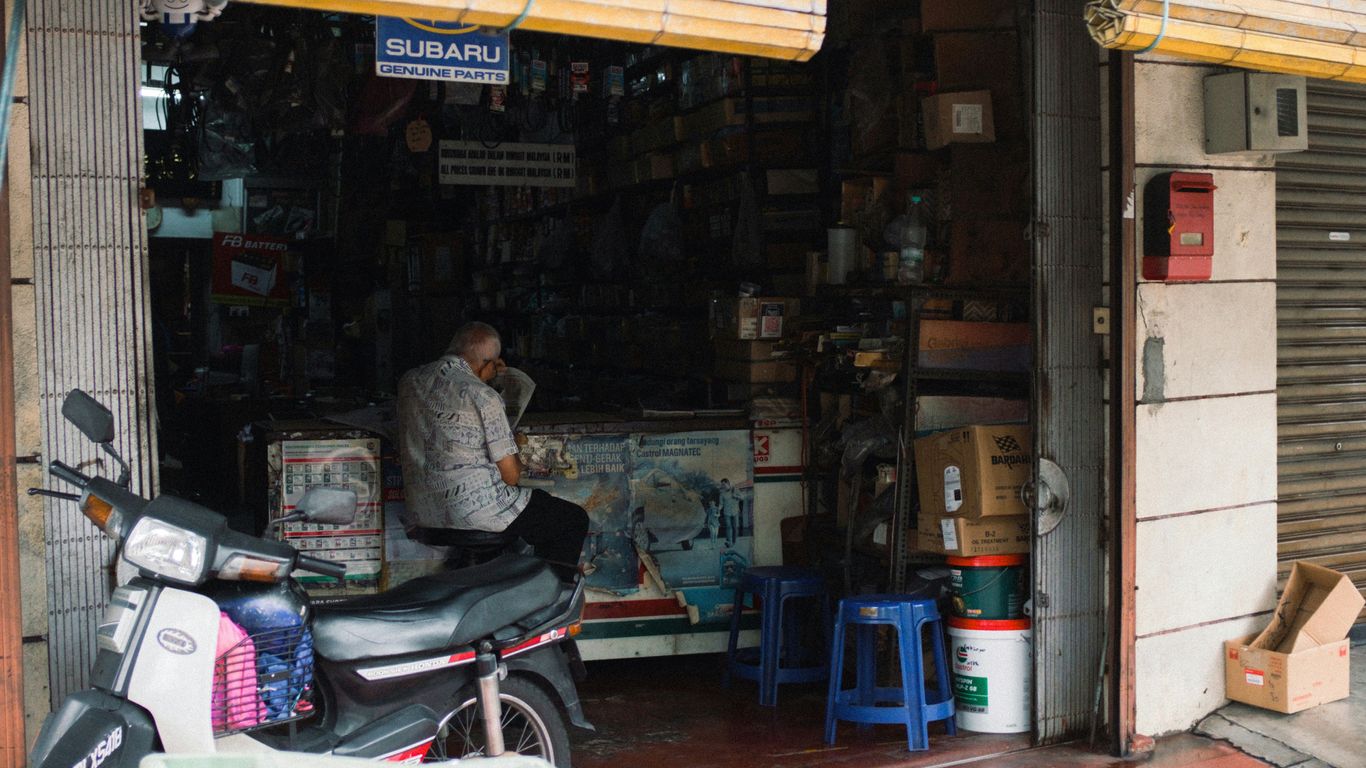 A motorcycle parked in front of a store