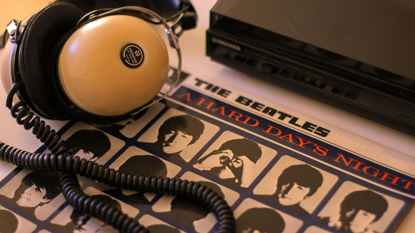 Headphones and a beatles album ready for listening.