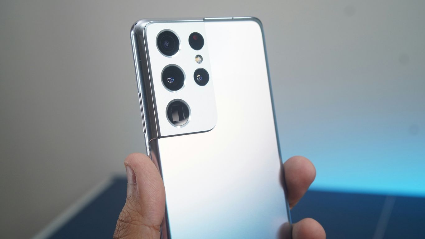 a hand holding a white rectangular device