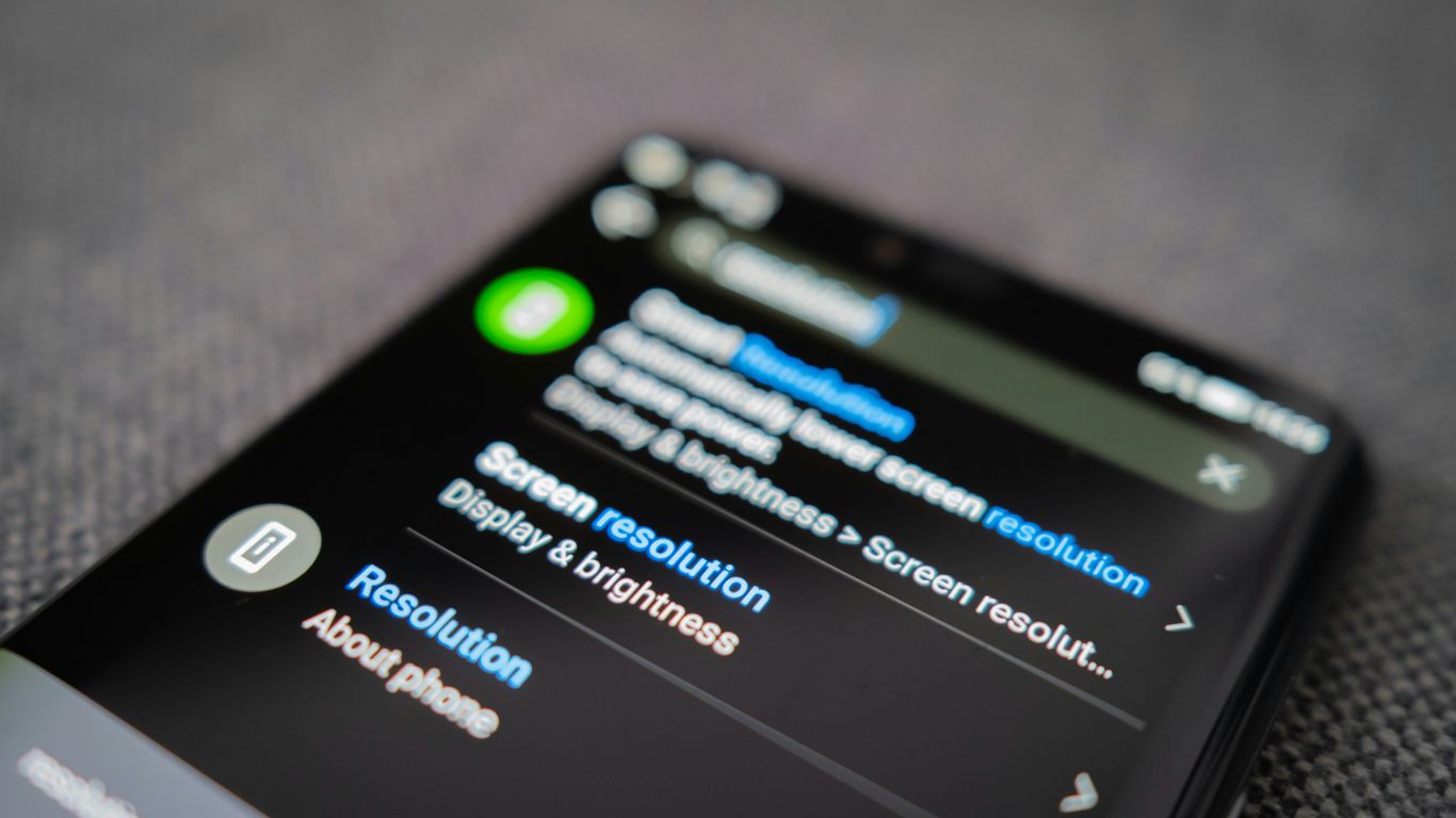 black android smartphone on gray textile