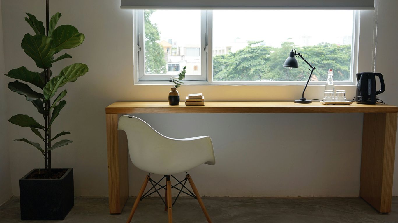 white wooden table near window
