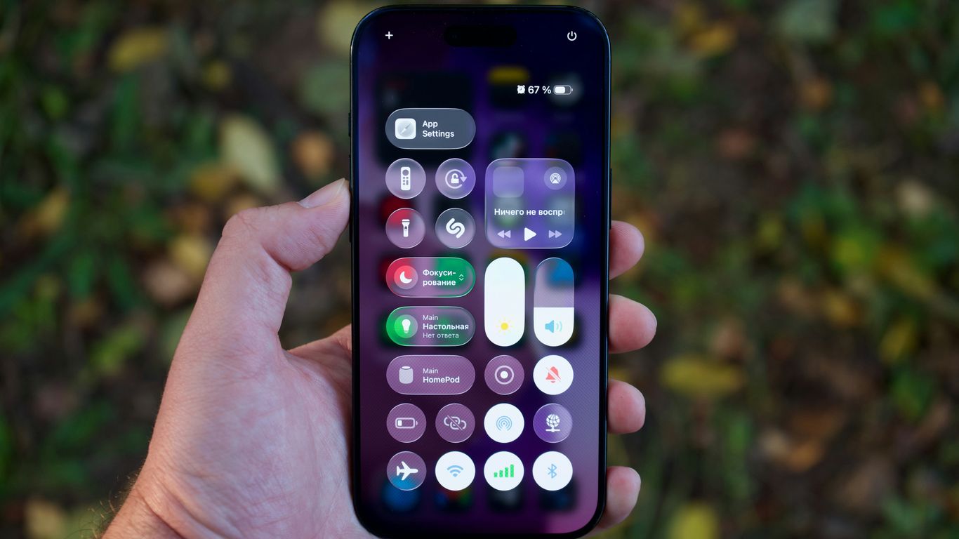 Hand holding a smartphone with colorful app icons.