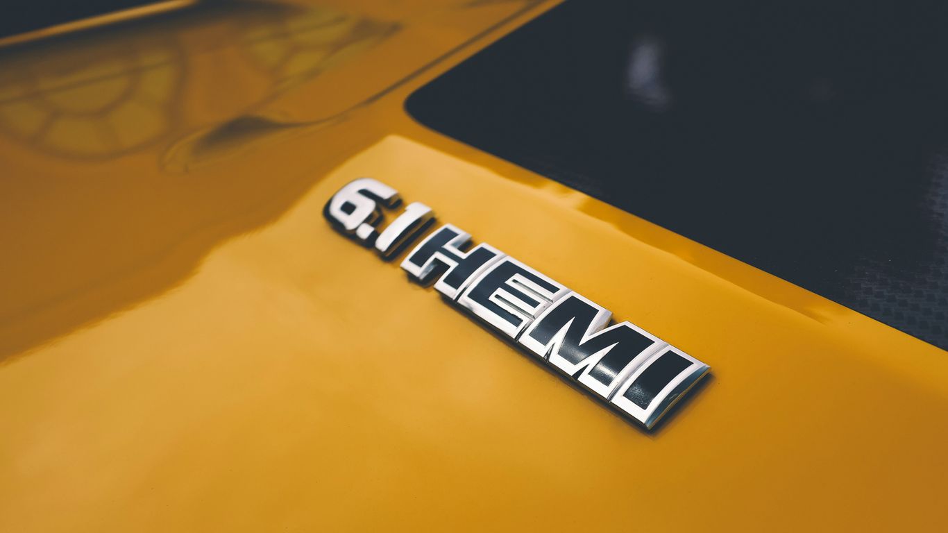 a close up of the emblem on a yellow sports car