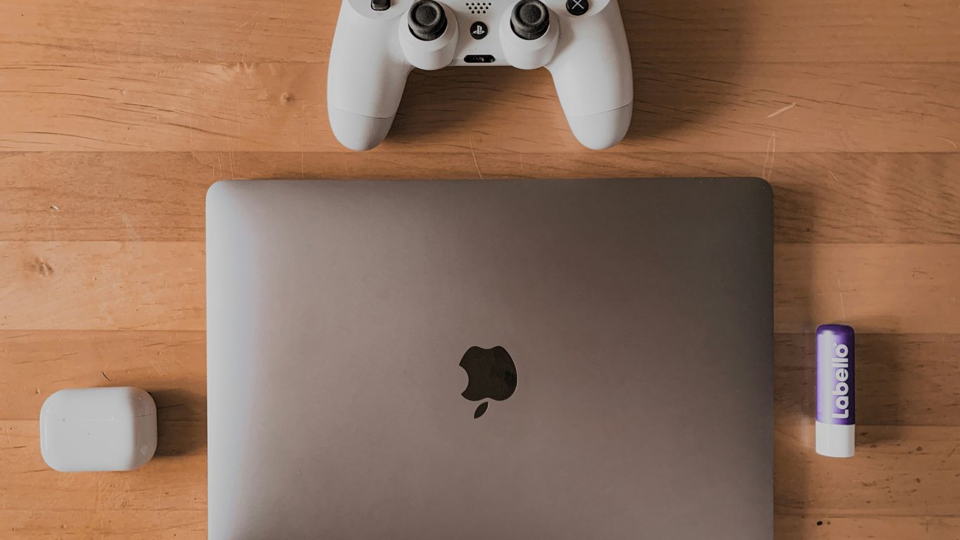 a laptop computer sitting on top of a wooden table