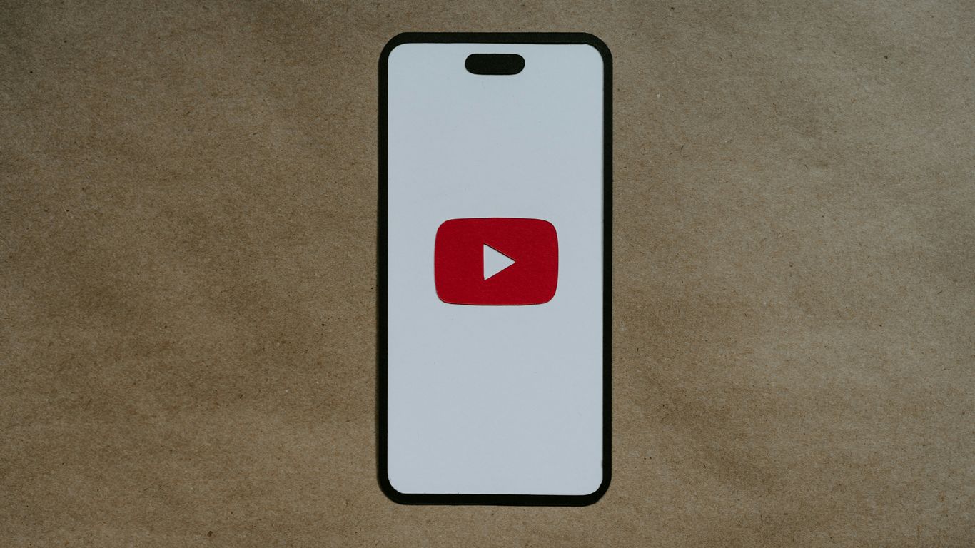a white phone with a red youtube logo on it