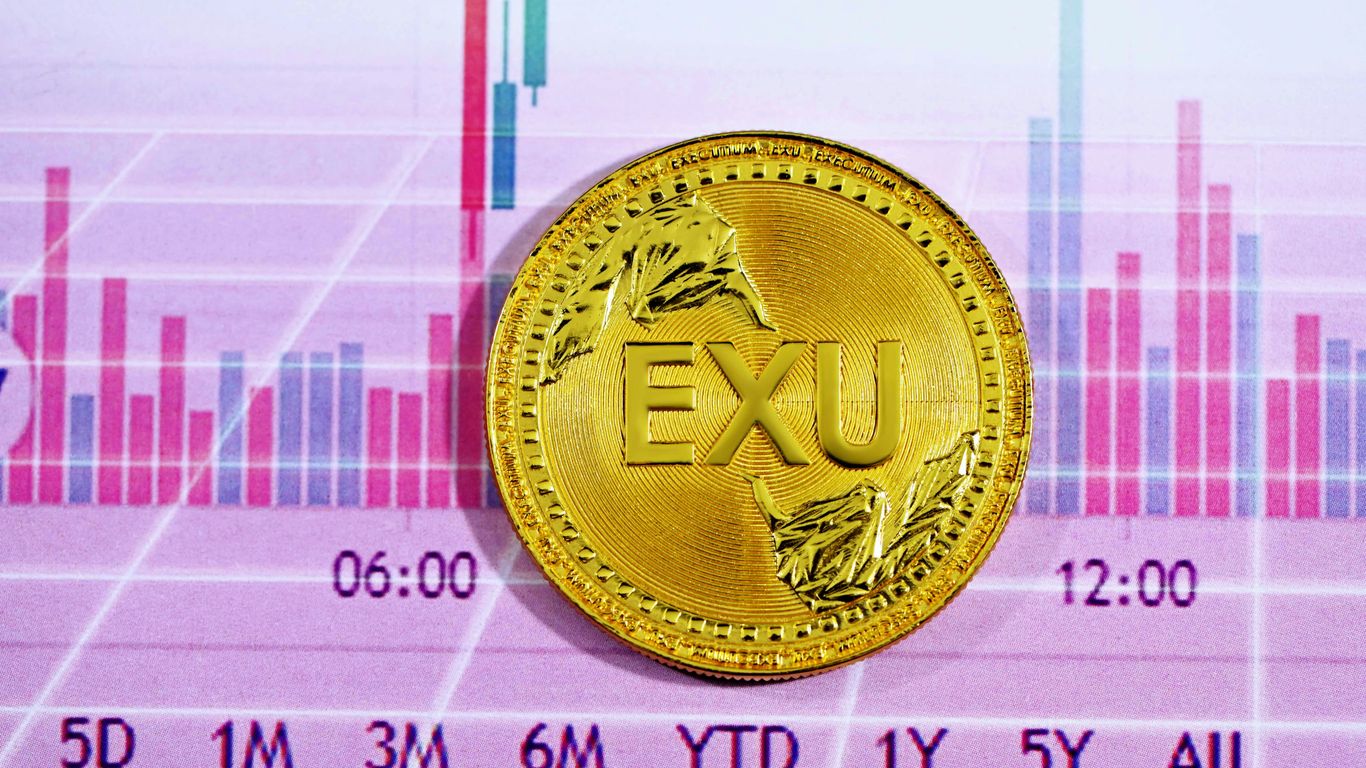 gold round coin on pink and white textile