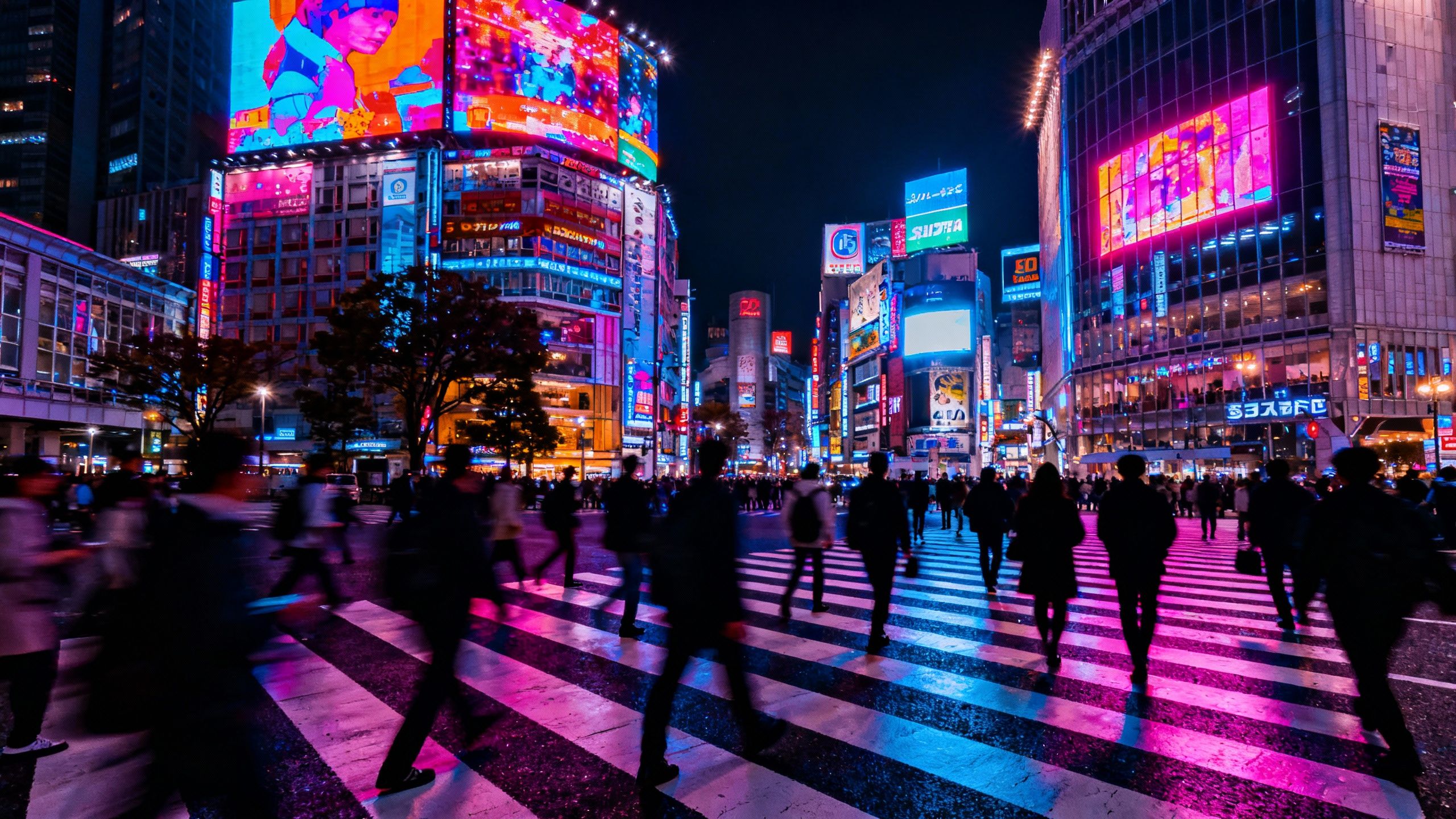 Shibuya Crossing, Tokyo, at night with neon lights and crowds.