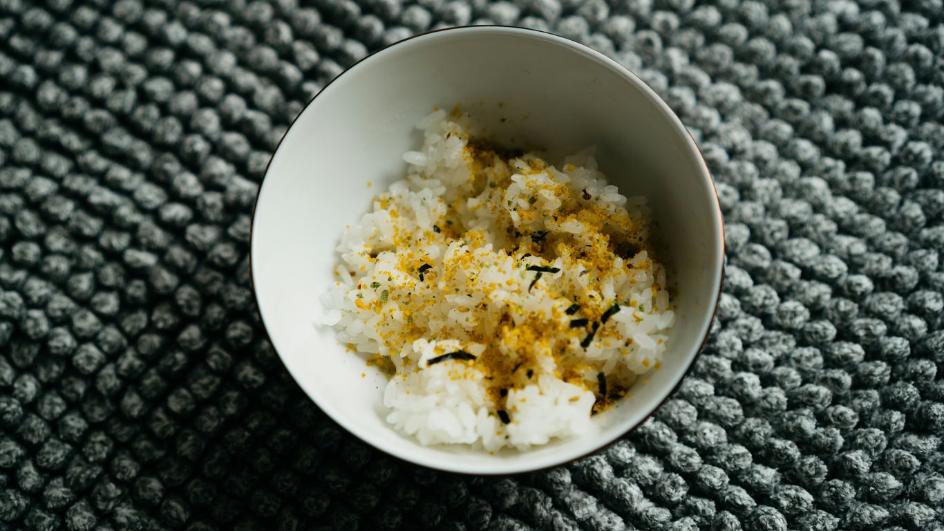 a white bowl filled with rice on top of a table