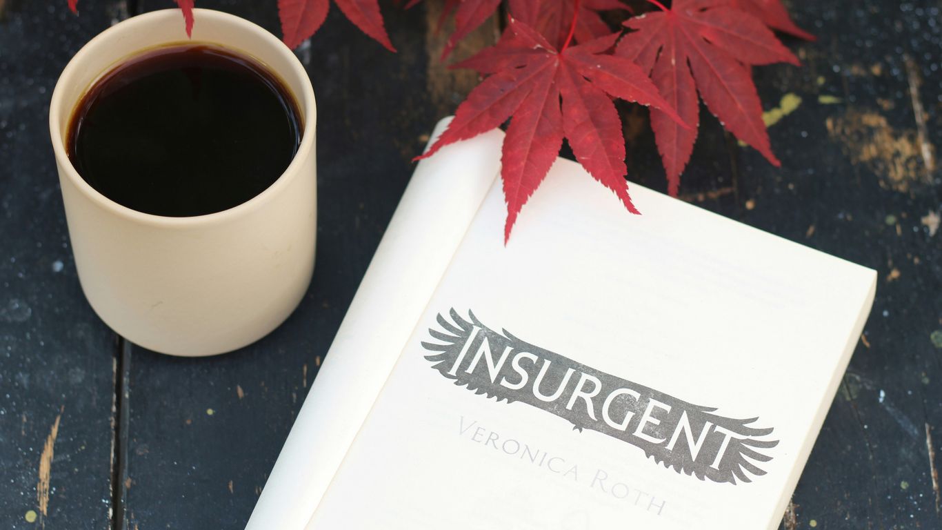 a cup of coffee and a book on a table