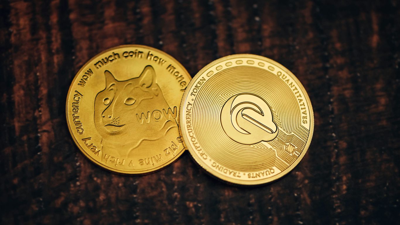 two gold coins sitting on top of a wooden table
