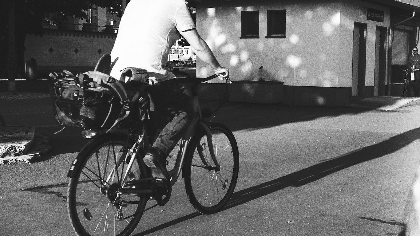 a man riding a bike down a street
