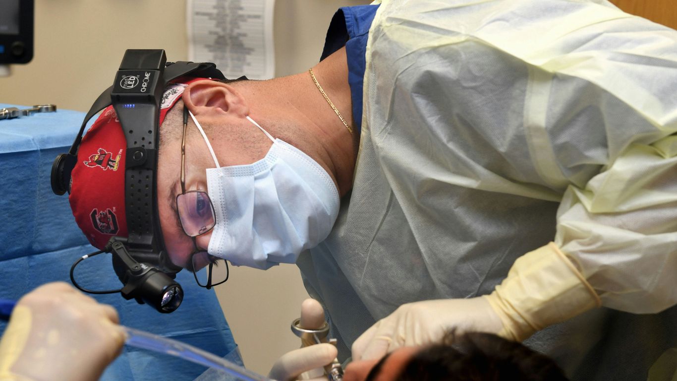 doctor using augmented reality headset in operating room