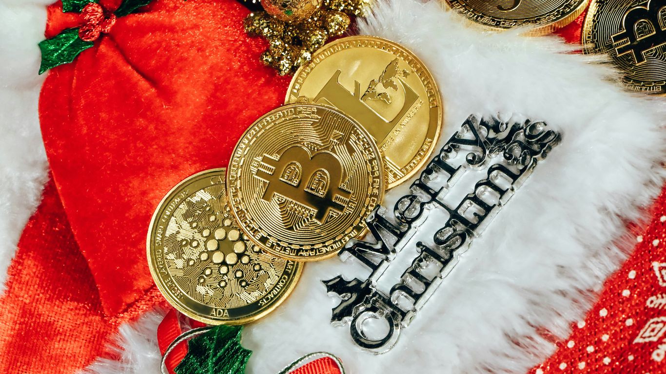 Bitcoin and cryptocurrency coins on a festive Christmas-themed background.