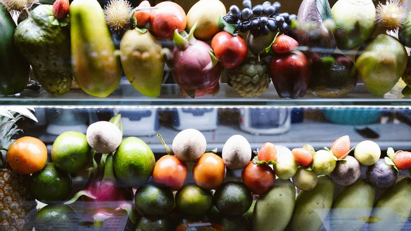 A display case filled with lots of different types of fruit