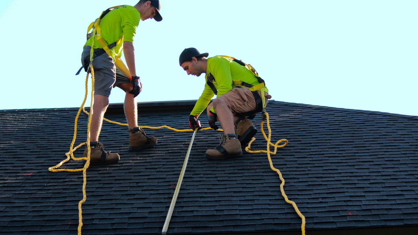 a couple of people that are on a roof