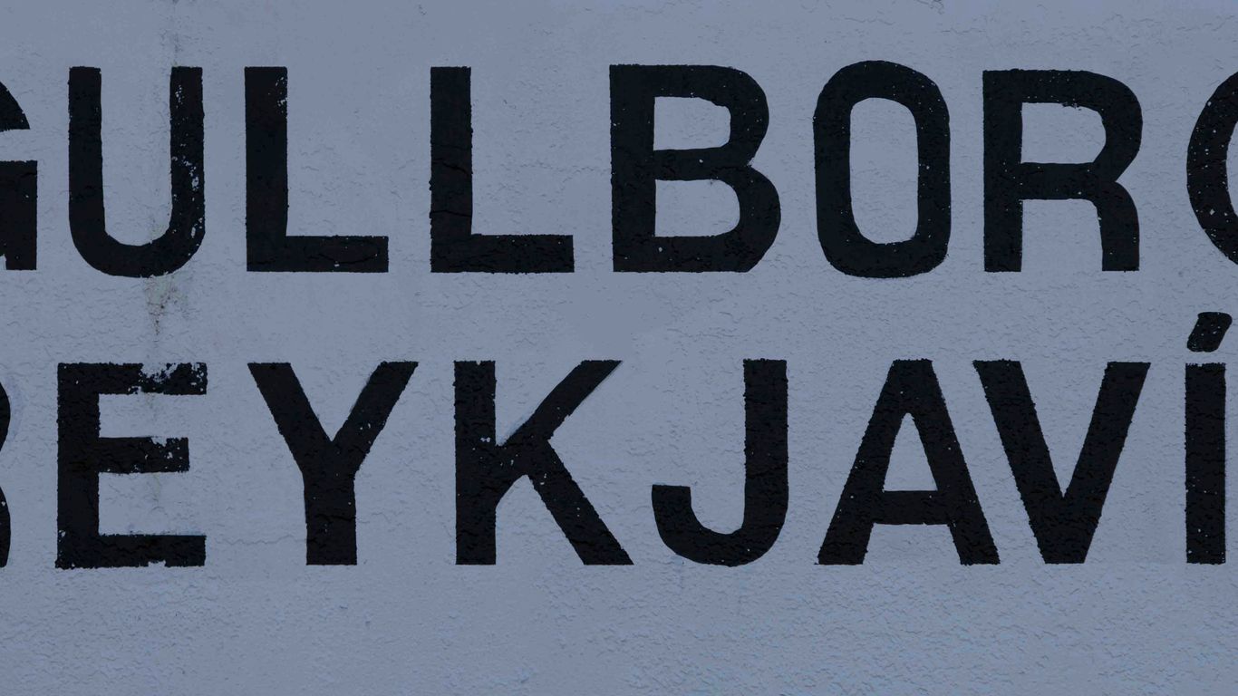 a white sign with black writing on it