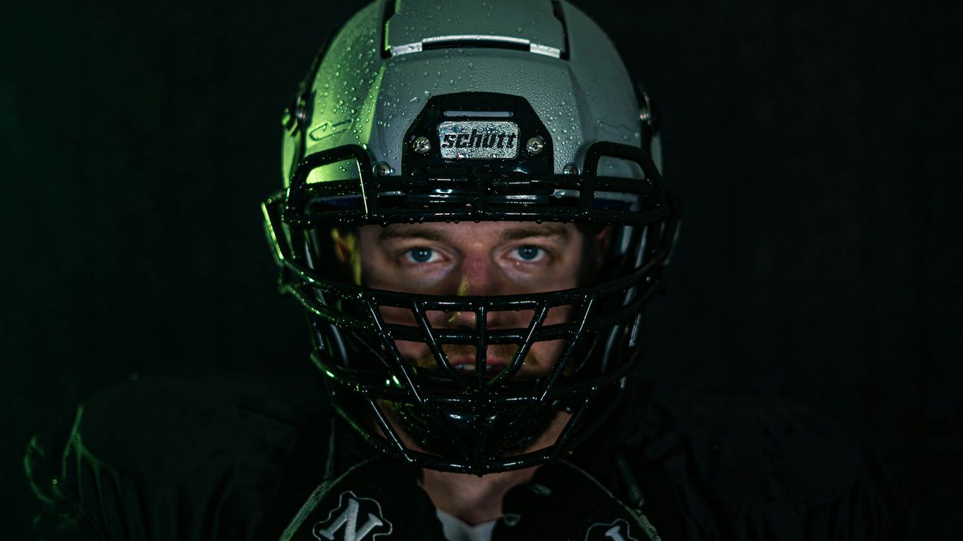 green and black helmet on black textile