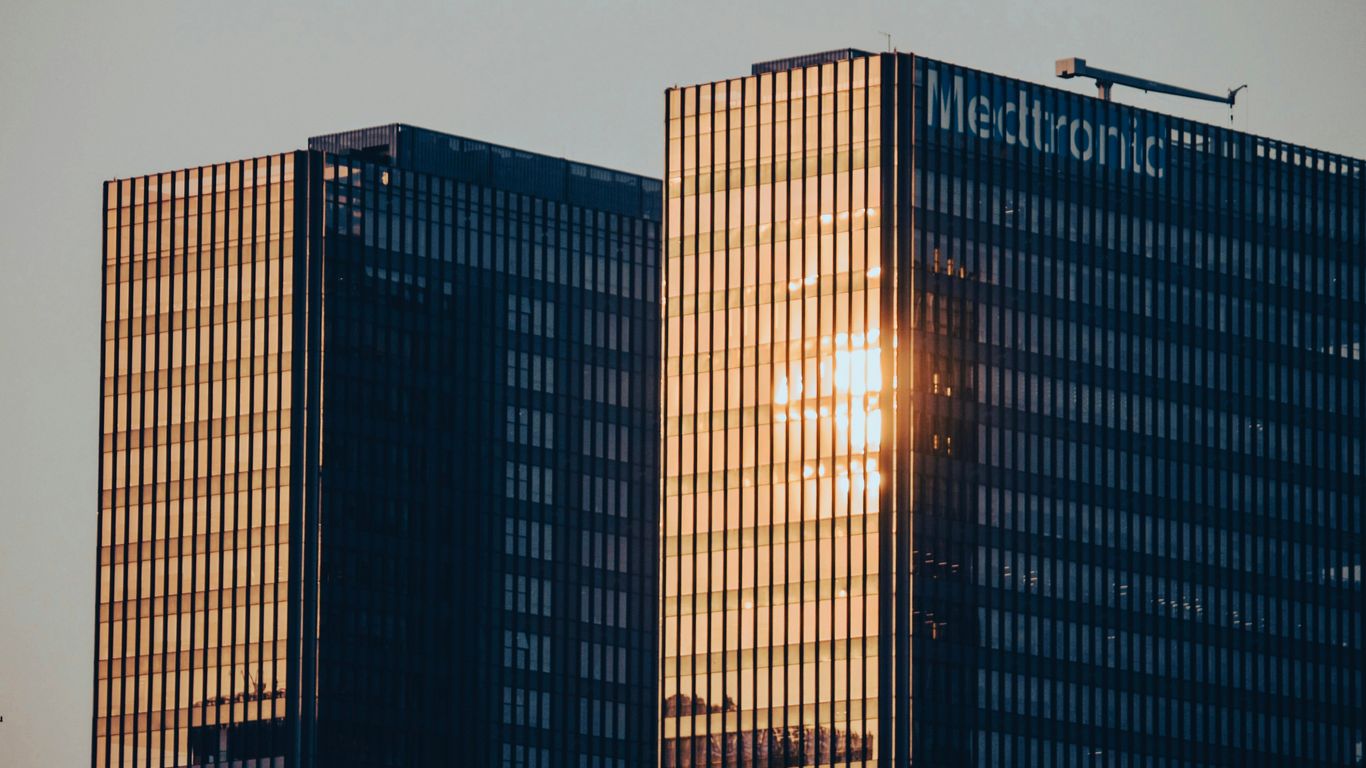A couple of tall buildings sitting next to each other
