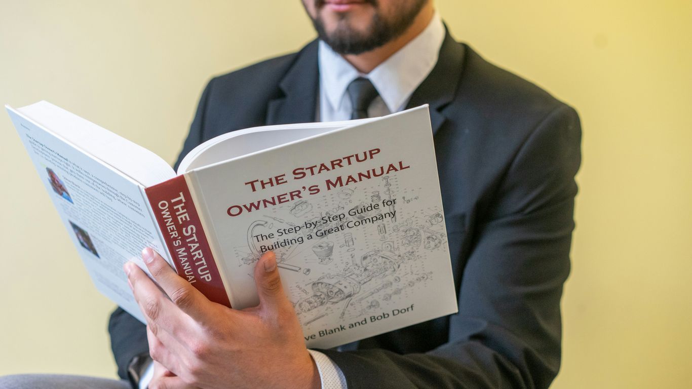 a man in a suit is reading a book