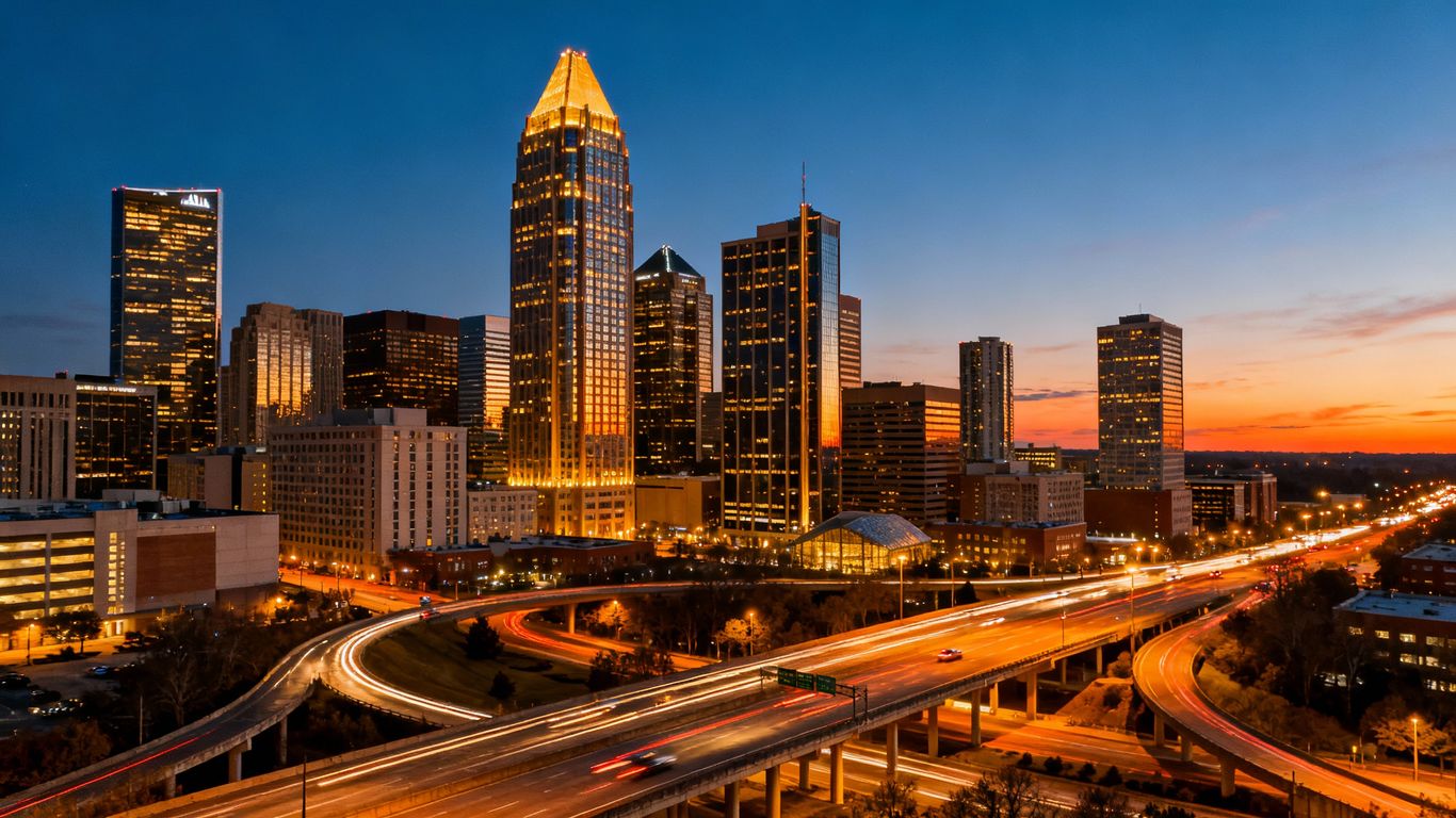 Atlanta cityscape at dusk with glowing skyscrapers and roads.