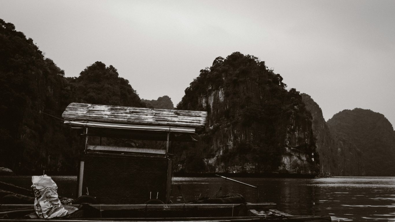 A black and white photo of a boat in a body of water