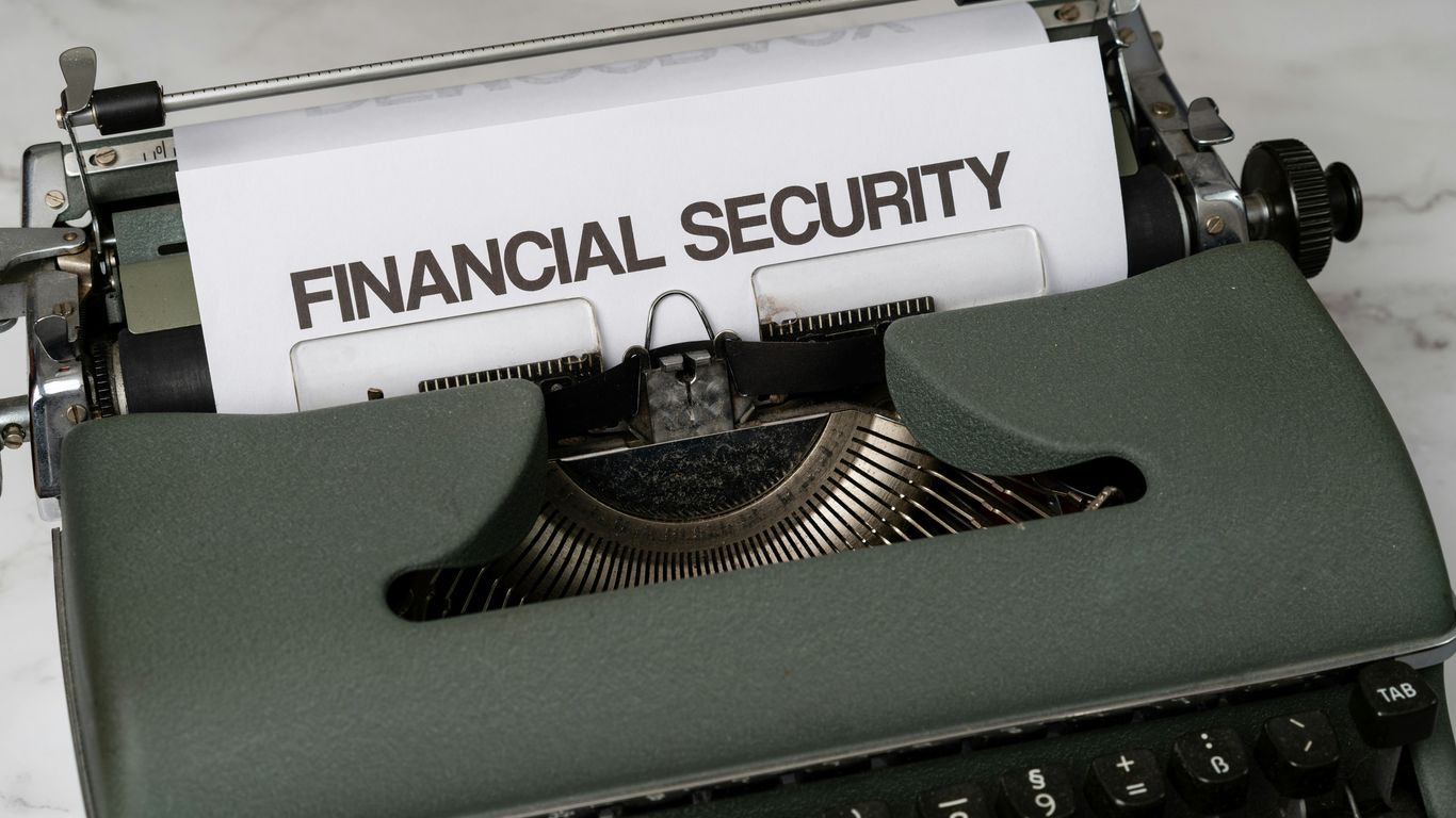 a close up of a typewriter with a financial security sign on it