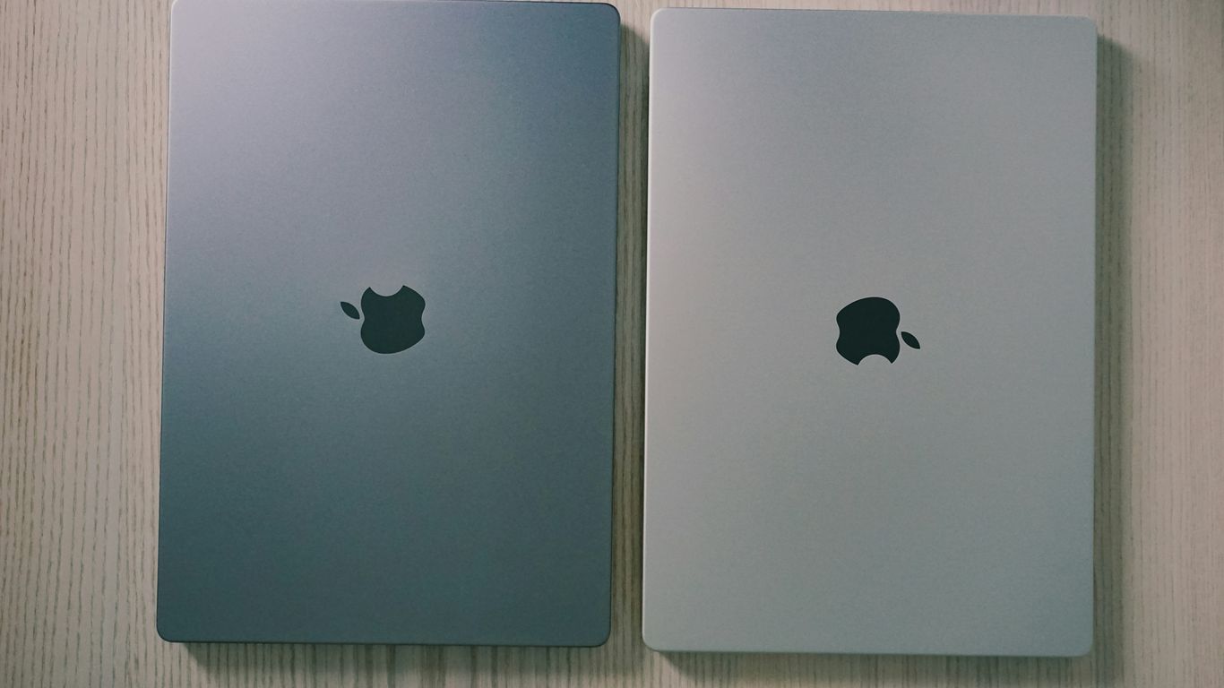 two silver ipads side by side on a wooden surface