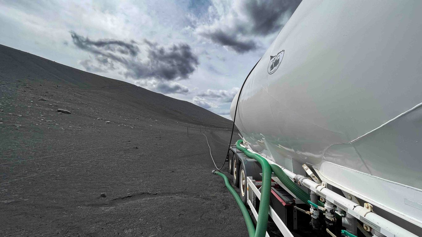 a boat sitting on top of a sandy beach