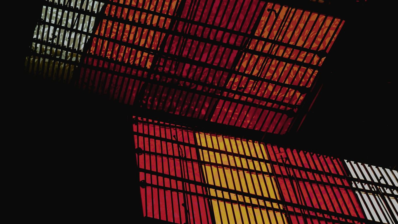 a close up of a metal structure with red and yellow squares