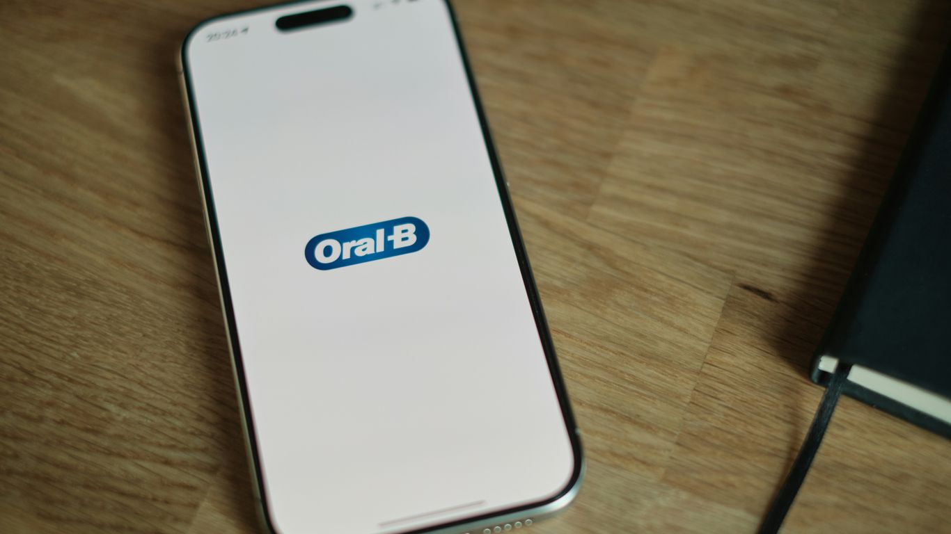 A cell phone sitting on top of a wooden table
