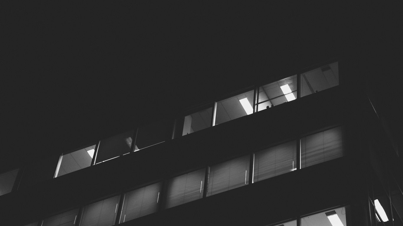 a black and white photo of a building at night