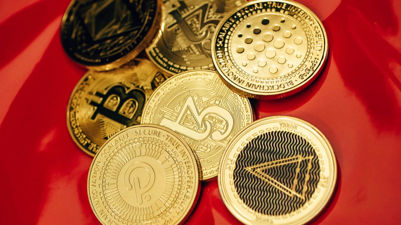 a pile of bitcoins sitting on top of a red table