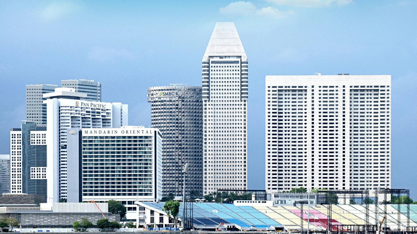 a city with a lot of tall buildings next to a body of water