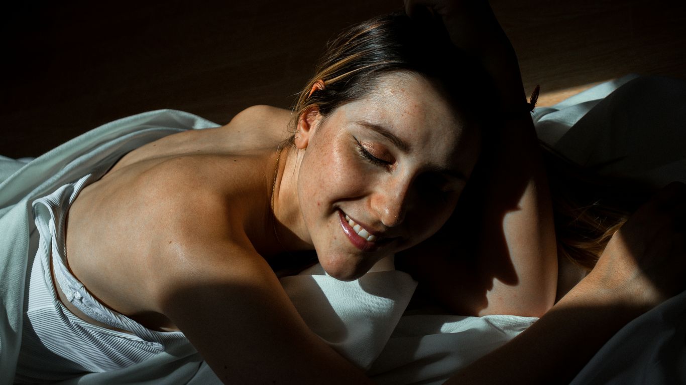 topless woman lying on bed