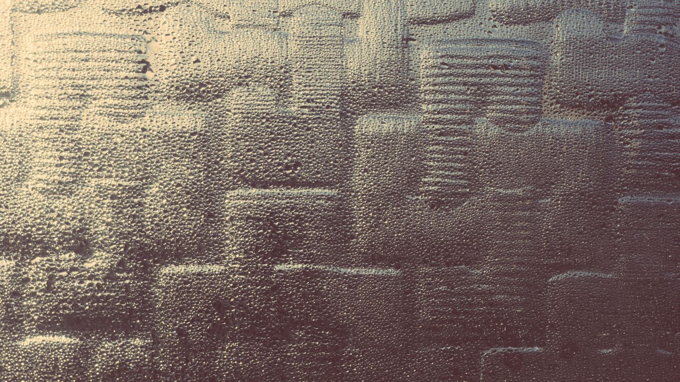 a close up of a window with rain drops