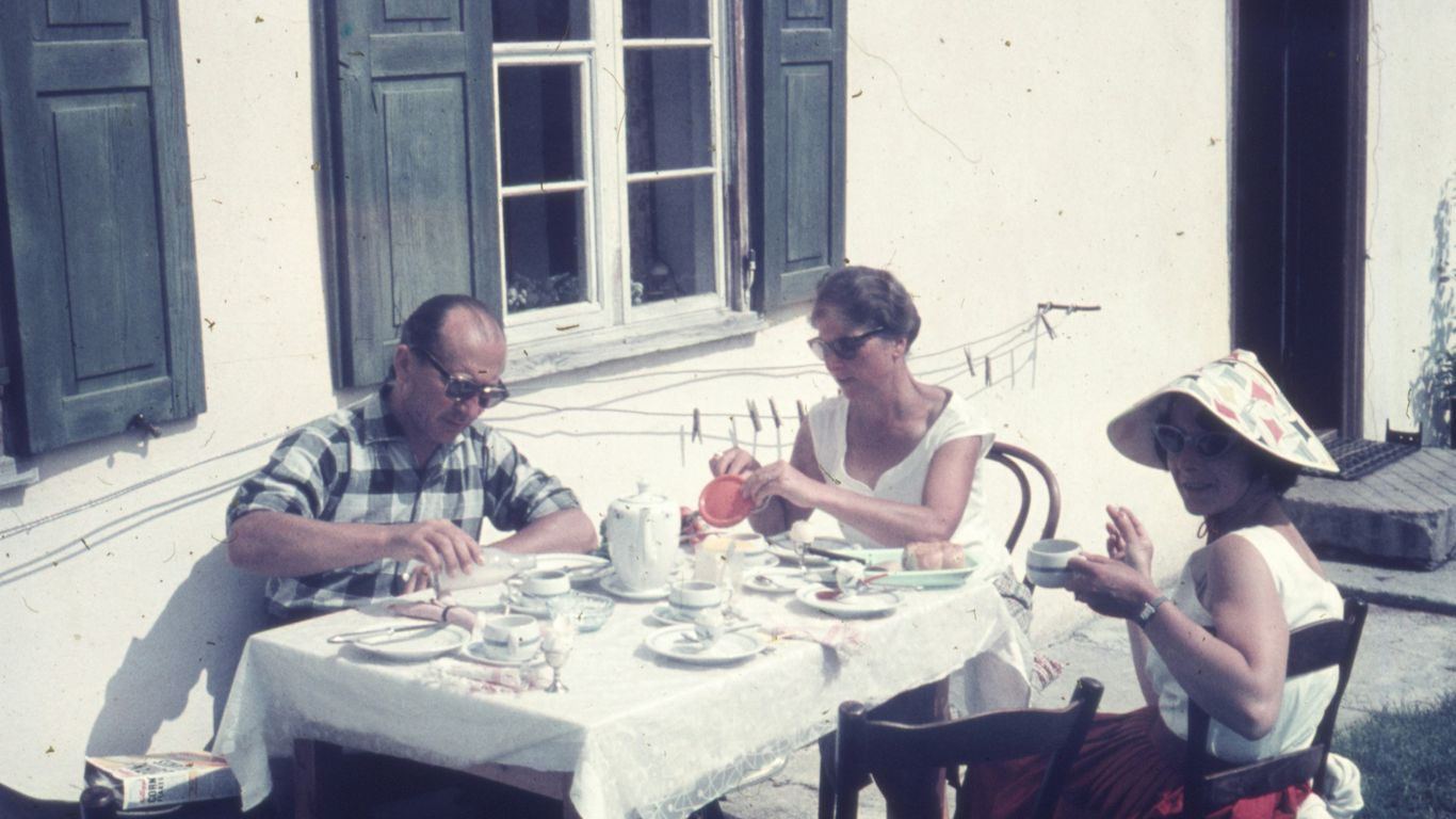 a group of people sitting at a table outside