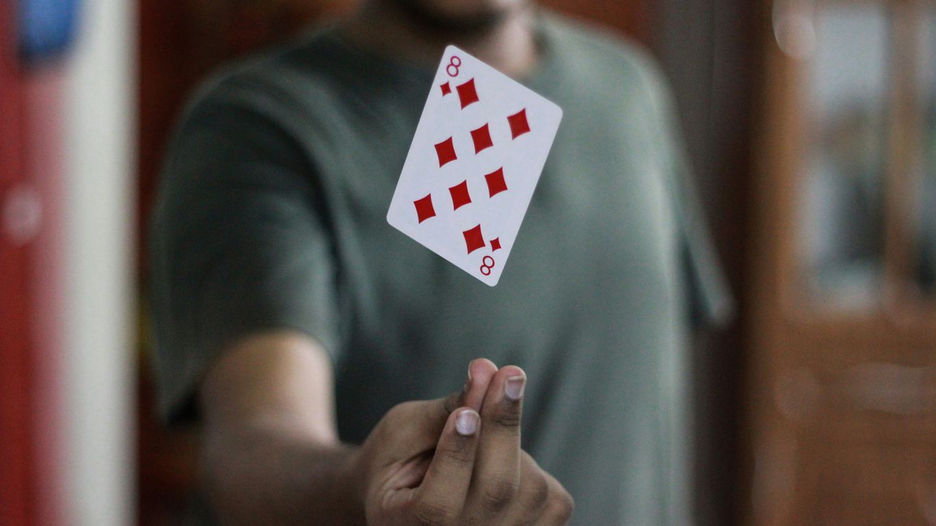 a man holding a playing card in his hand